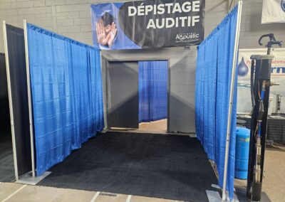 Espace privé de dépistage aménagé avec des séparateurs de rideaux bleus